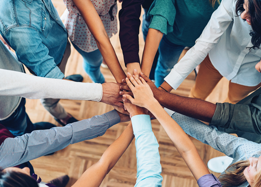 People putting hands together in a circle